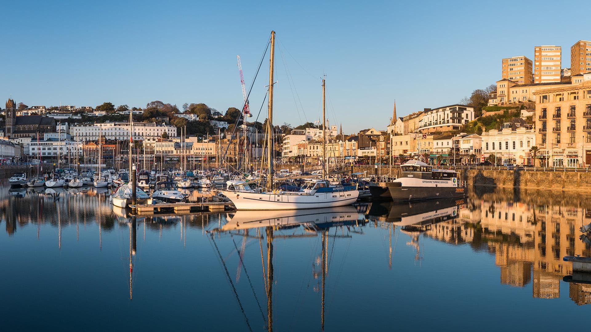 Torquay harbor with boats and waterfront buildings
